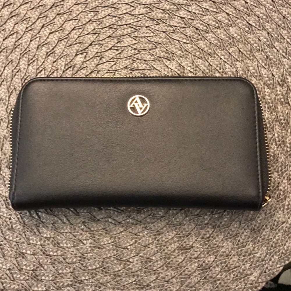 Black leather wallet. Like new! All zippers work!